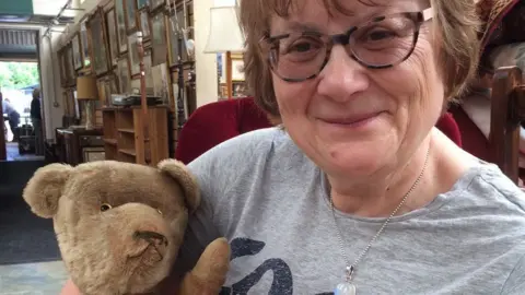 Hansons Auctioneers Jenny with Bear in the saleroom at Hansons.