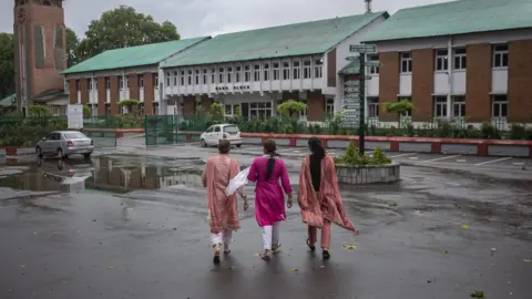 Abid Bhat Women walk towards a school in Srinagar