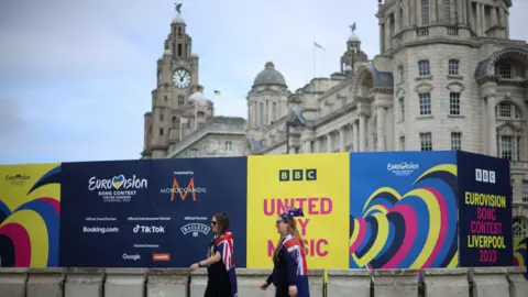 Reuters Eurovision fans wearing Australian flags, walk near the fanzone