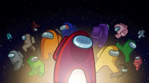 Innersloth An illustration featuring a selection of characters from Among Us on a black background dotted with stars. A red character, with an oval visor, is in the centre of the shot surrounded by orange, blue, purple, yellow and green versions behind. The blue character sports a red glint over his visor and a knife can be seen in his hand - denoting that he is the imposter.