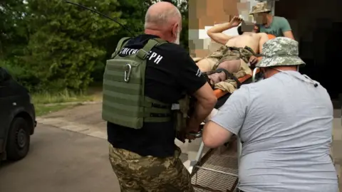 Jess Daly Surgeon injured by a landmine being carried on a stretcher