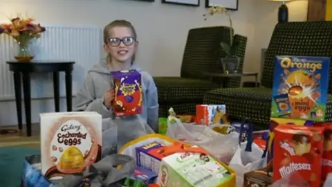 Clarissa with some of the Easter eggs that have been donated