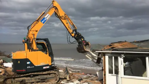 Digger demolishing chalet