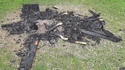 Our Bodies Our Streets Remains of sculpture after arson attack