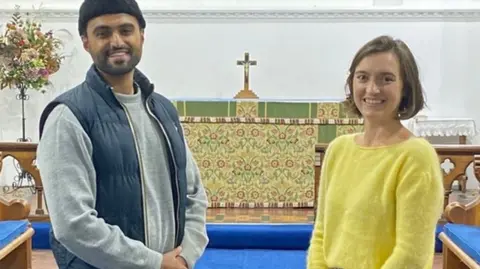 Sabah Ahmedi, 28, (left) who is one of Britain's youngest Imams, with Charlotte Mathias, treasurer at All Saints Church in Tilford, Surrey