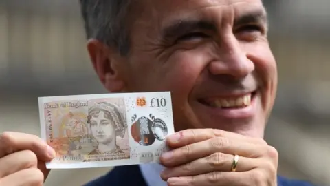 Getty Images Mark Carney with new £10 note