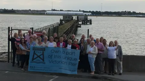 Steve Chicken Campaigners celebrate by the pier