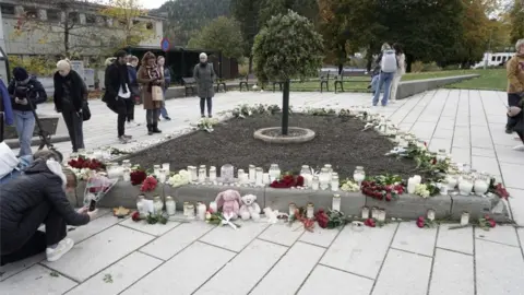 EPA People in Kongsberg place tributes for the dead after an attack which left five people dead in the town