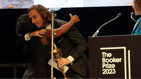 Author Paul Lynch hugs Esi Edugyan after winning prestigious award