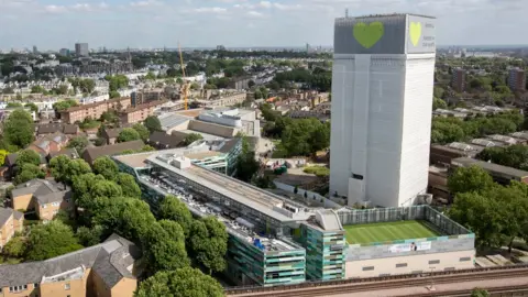 PA Grenfell tower covered in plastic sheeting after the disaster