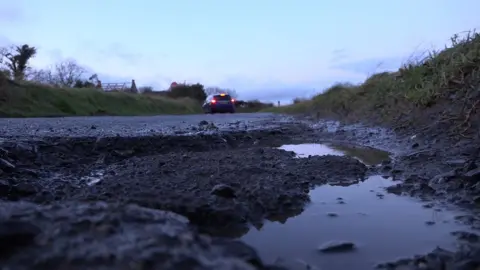 BBC The recent cold snap may have made the pothole problem even worse