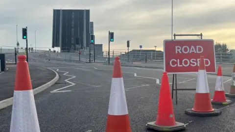 Andrew Turner/BBC Road closed sign and cones on approach to Herring Bridge in the raised position