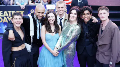 PA Media The cast (front) Lara McDonnell, and (back, left to right) Mark Samaras, Dalvin Cory, Aisling Bea, Joshua Jung, Mervin Noronha and Aaron Bryan attend the premiere of Greatest Days, at Odeon Leicester Square in central London