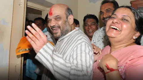 Getty Images Amit Shah with his wife Sonal Shah on his arrival home after his release from Sabarmati Jail in Ahmedabad on October 29, 2010