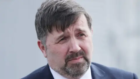 Niall Carson Health Minister Robin Swann