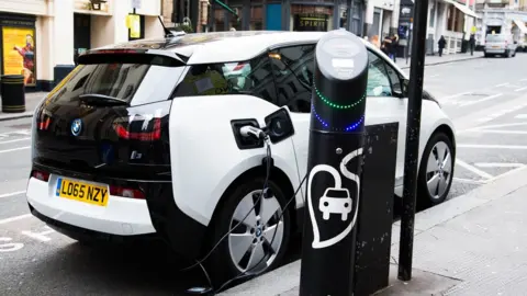 Getty Images Electric car being recharged at a meter in London