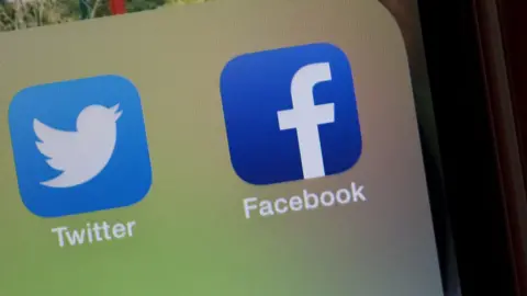PA Facebook and Twitter logos on phone