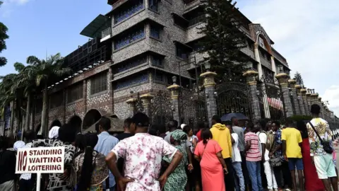AFP Residents and church members gather at the main gate of The Synagogue Church of All Nations (SCOA) headquarters to mourn the death of late Nigerian pastor TB Joshua, in the Ikotun distrcit of Lagos on June 6, 2021
