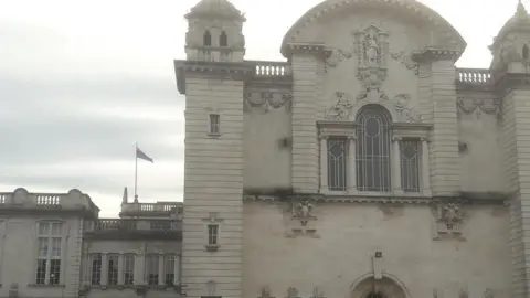 Cardiff University The bi-visibility flag in pink, lavender and blue flying over Cardiff University