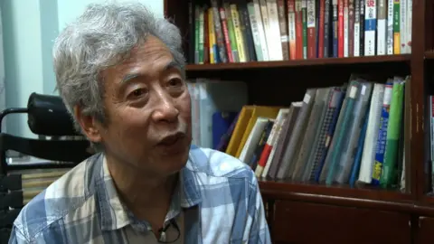 Getty Images Screen grab taken from AFP video footage shows former professor Sun Wenguang talking in his home in Jinan, 2013