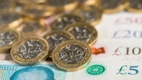 PA Media UK £5, £10, £20 and £50 notes with one pound coins