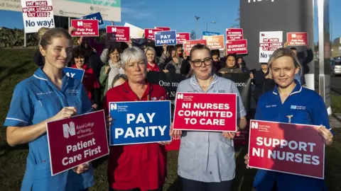 PA Media Nurses on strike holding placards outside the Ulster Hospital