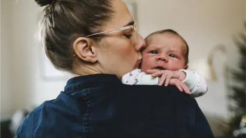 Getty/Johner Images Stock image of a mum and baby