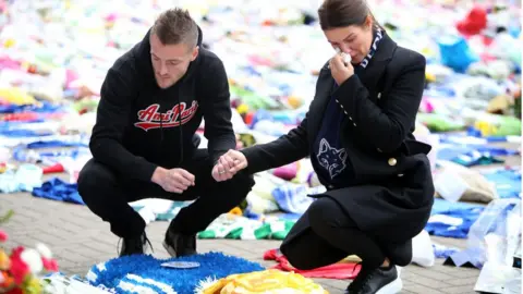 Plumb Images / Getty Images Jamie and Becky Vardy visit memorial