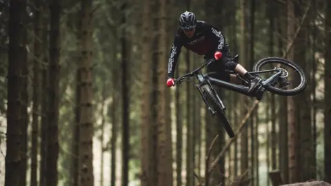 Roo Fowler A cyclist doing a stunt on an e-bike