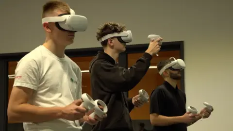 Dawid Wojtowicz/BBC Students wearing virtual reality headsets that will be used in teaching