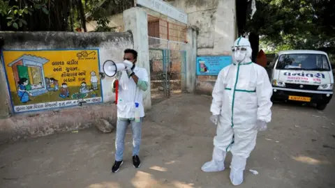 Reuters Healthcare workers in parts of India are currently going door-to-door to survey for Covid-19