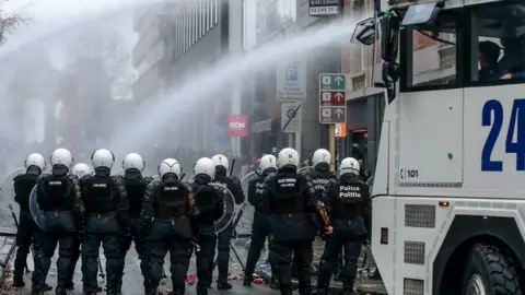 Water cannons are fired at protesters in Belgium