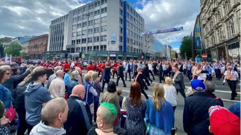 Thousands of spectators lined the route of the parade from Stormont to Belfast city centre