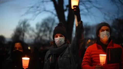 PA Media People holding candles on Clapham Common