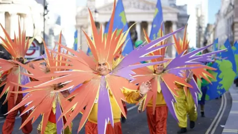 PA Media Performers in bright costumes take part in the Lord Mayor's Show in the City of London