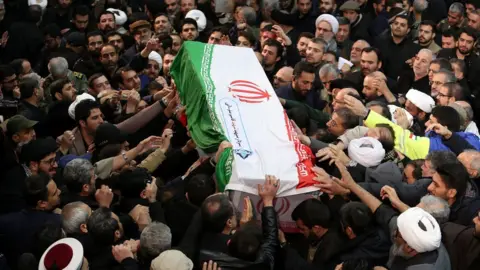 Reuters Iranian people carry the coffin of Qasem Soleimani during a funeral procession in Tehran, 6 January 2020