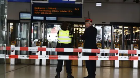 AFP Officials stand inside a cordoned-off area at The Central Railway Station in Amsterdam on August 31, 2018,