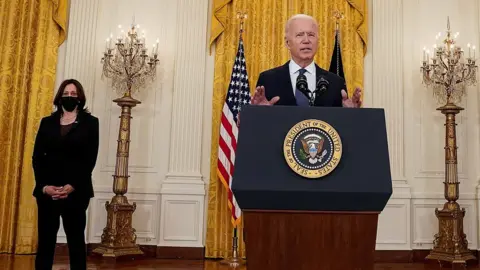 Reuters US President Joe Biden speaks, watched by Vice-President Kamala Harris