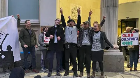 The four defendants celebrated outside the court after being found not guilty