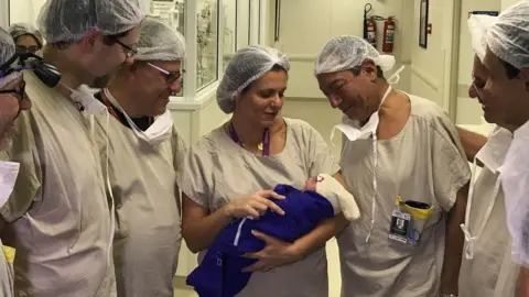 Reuters Medical team hold the baby