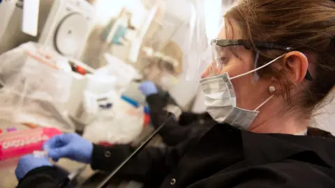 Reuters A female scientist in a coronavirus testing lab