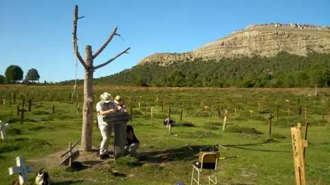 Volunteers maintaining restored site of Sad Hill cemetery scene
