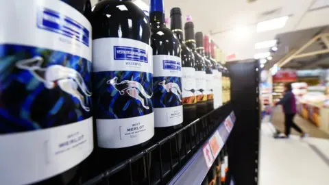 Getty Images Bottles of Australian wine in supermarket aisle.