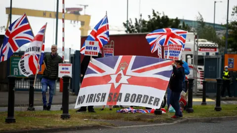 Reuters Unionists holding union flags and placards protest against the post-Brexit trade arrangements affecting Northern Ireland