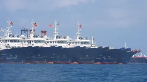 EPA Chinese vessels moored at a reef in the disputed South China Sea, 7 March 2021