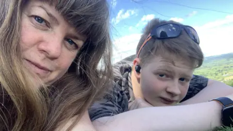 BBC A selfie of Serena Wootton and her son lying on the grass