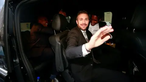 Reuters  ASAP Rocky (back right) smiling widely in a car as he leaves the district court