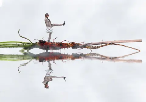 Peter Lawrance Composite image of a woman walking on a carrot