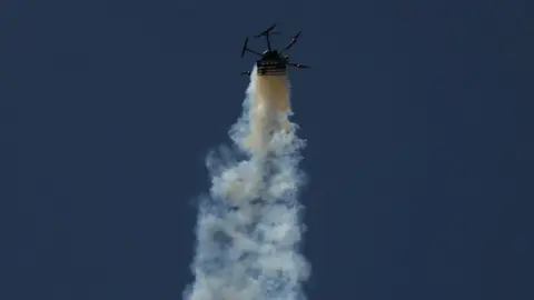 Reuters An Israeli military drone drops tear gas onto Palestinians at a protest near the Gaza-Israel border fence on 15 May 2018