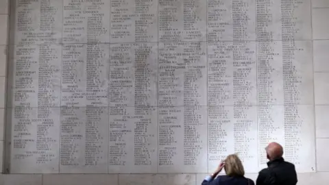 PA People look at the names of some of fallen soldiers on the Menin Gate in Ypres